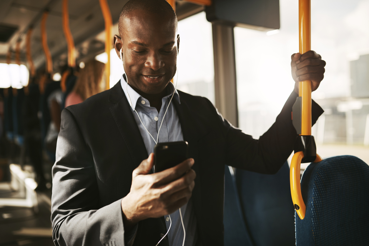 Recruiter checks for updates on their mobile device while commuting on a train